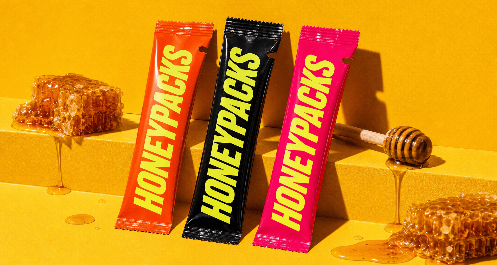 HoneyPacks sachets surrounded by honeycomb on a yellow set